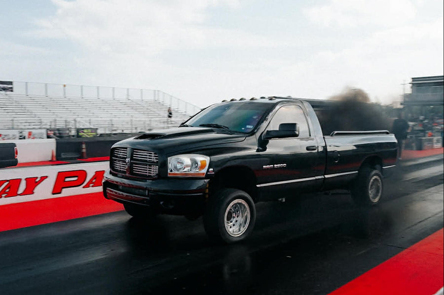 Black pickup truck on a racetrack with 'Raceway Park' branding.